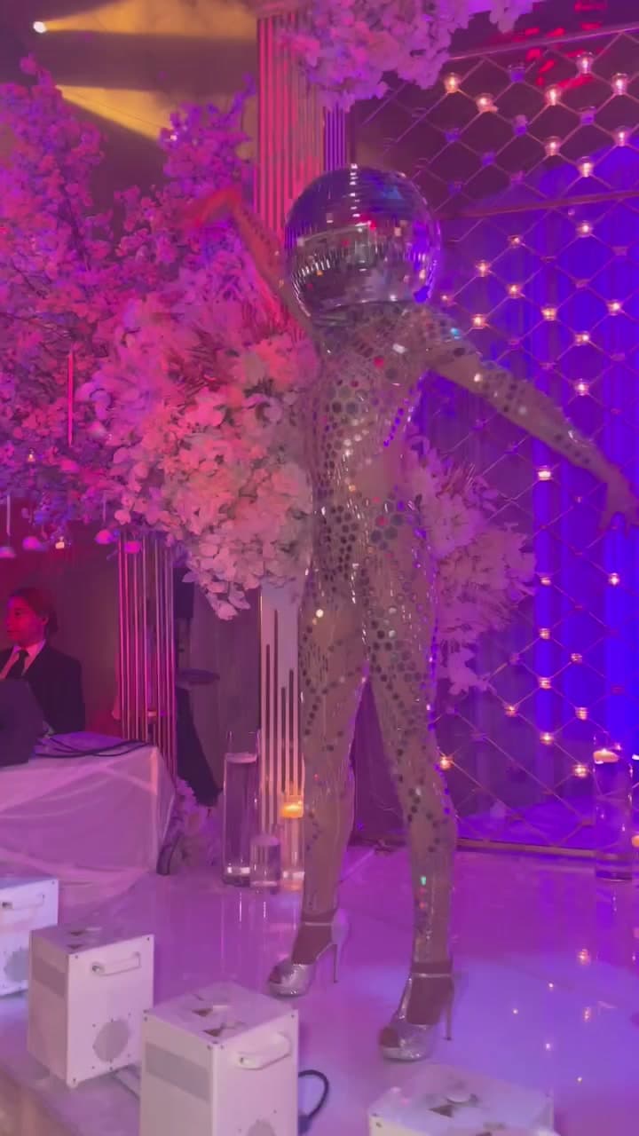 Disco ball head performer in mirrored bodysuit on a luxury reception dance floor