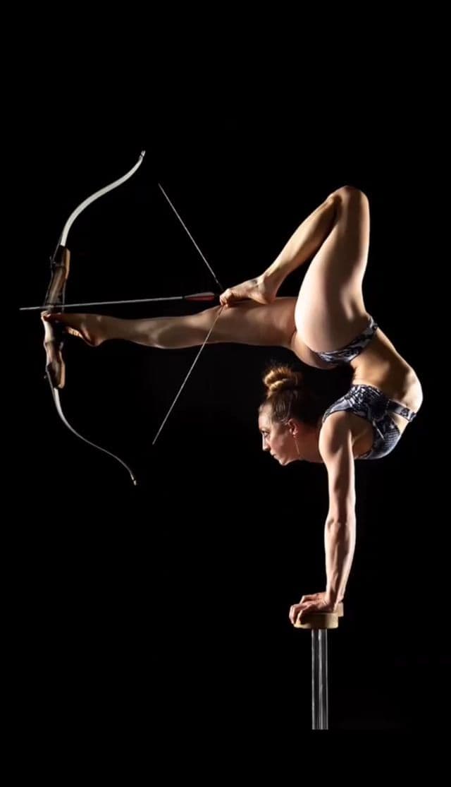 Handbalancing Contortionist with Foot Archery performer in costume at an event in the New York metropolitan area (image 1)
