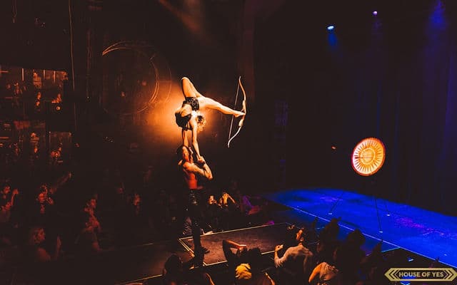Handbalancing Contortionist with Foot Archery performer in costume at an event in the New York metropolitan area (image 2)