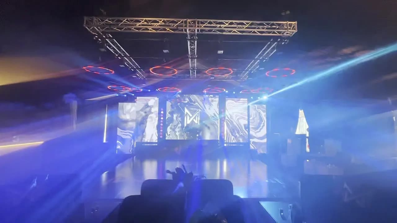 Blue beam lighting over an LED stage at an event produced by Nicholson Events