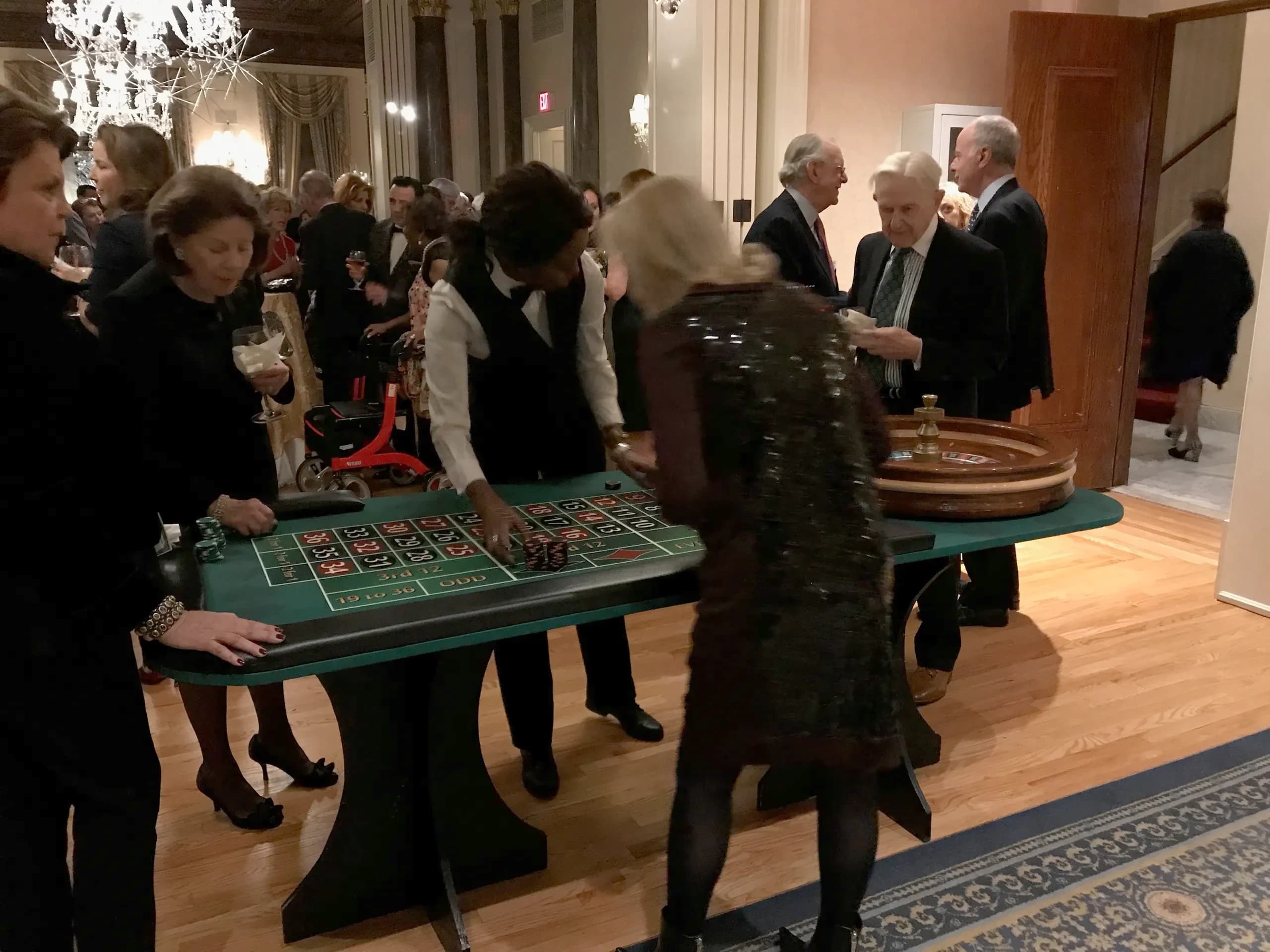 Professional casino dealers at a real craps table with chips in play at a Nicholson Events casino night