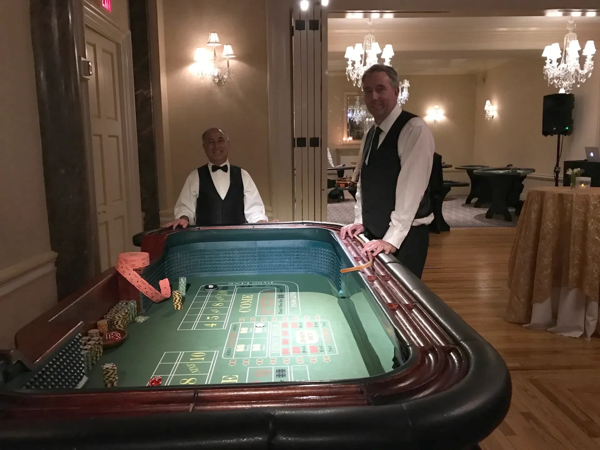 Elegant casino table setup with blackjack and roulette tables in an upscale venue for a charity fundraiser in Connecticut