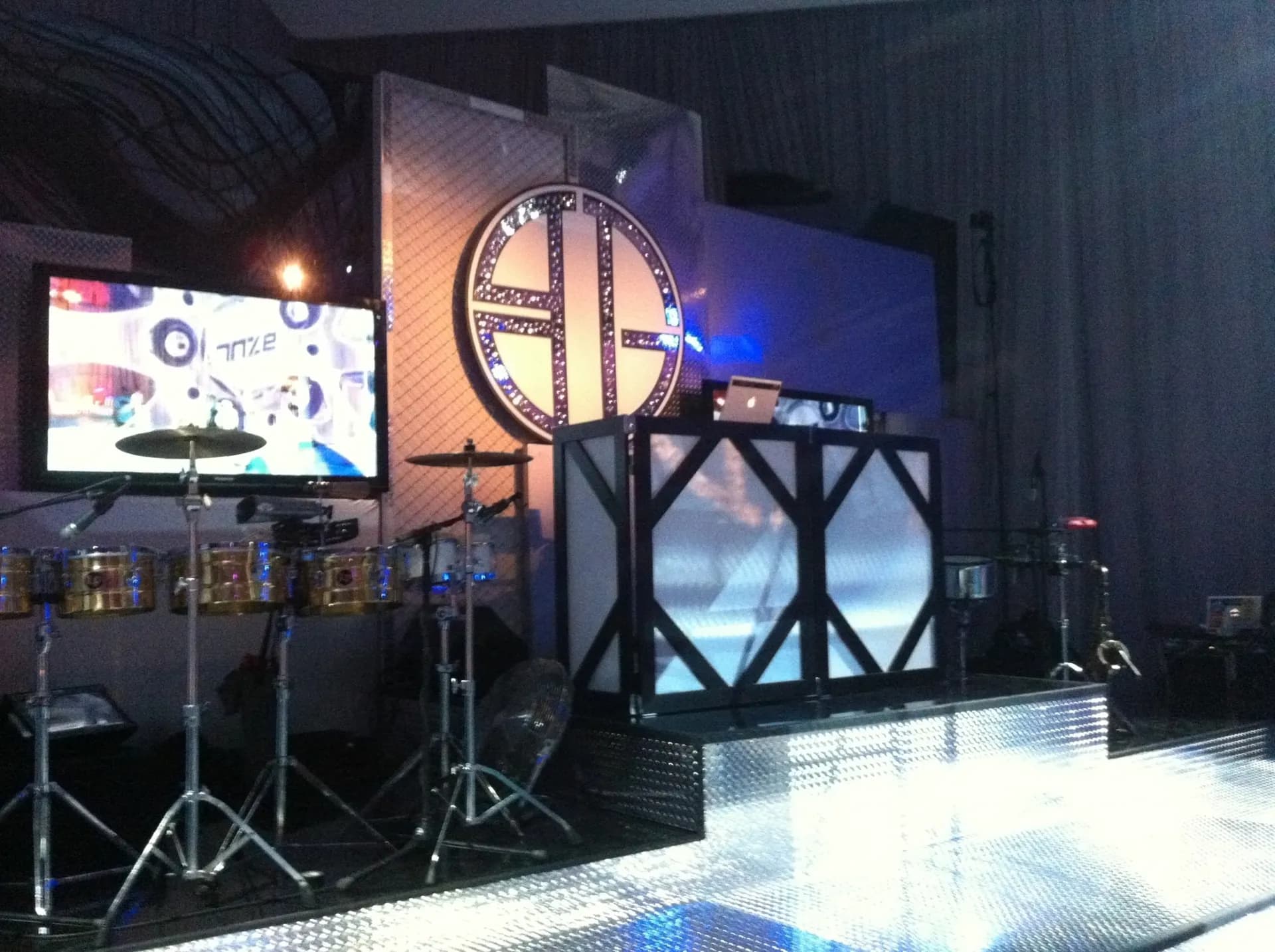 Custom LED DJ booth and stage setup for corporate event production with branded lighting
