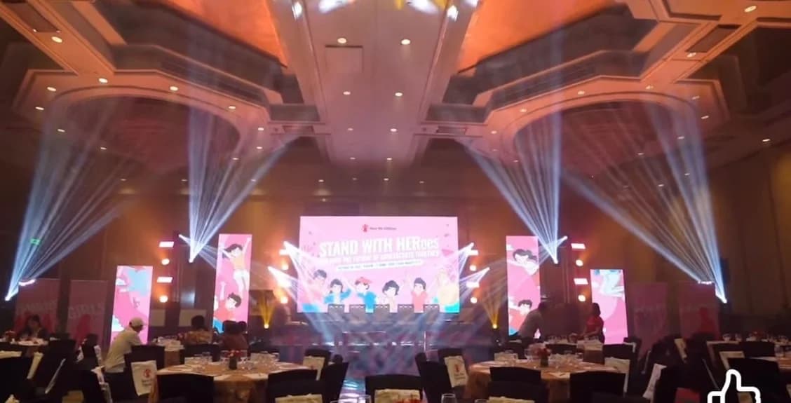 Grand ballroom gala with a large LED video wall stage and beam lighting produced by Nicholson Events