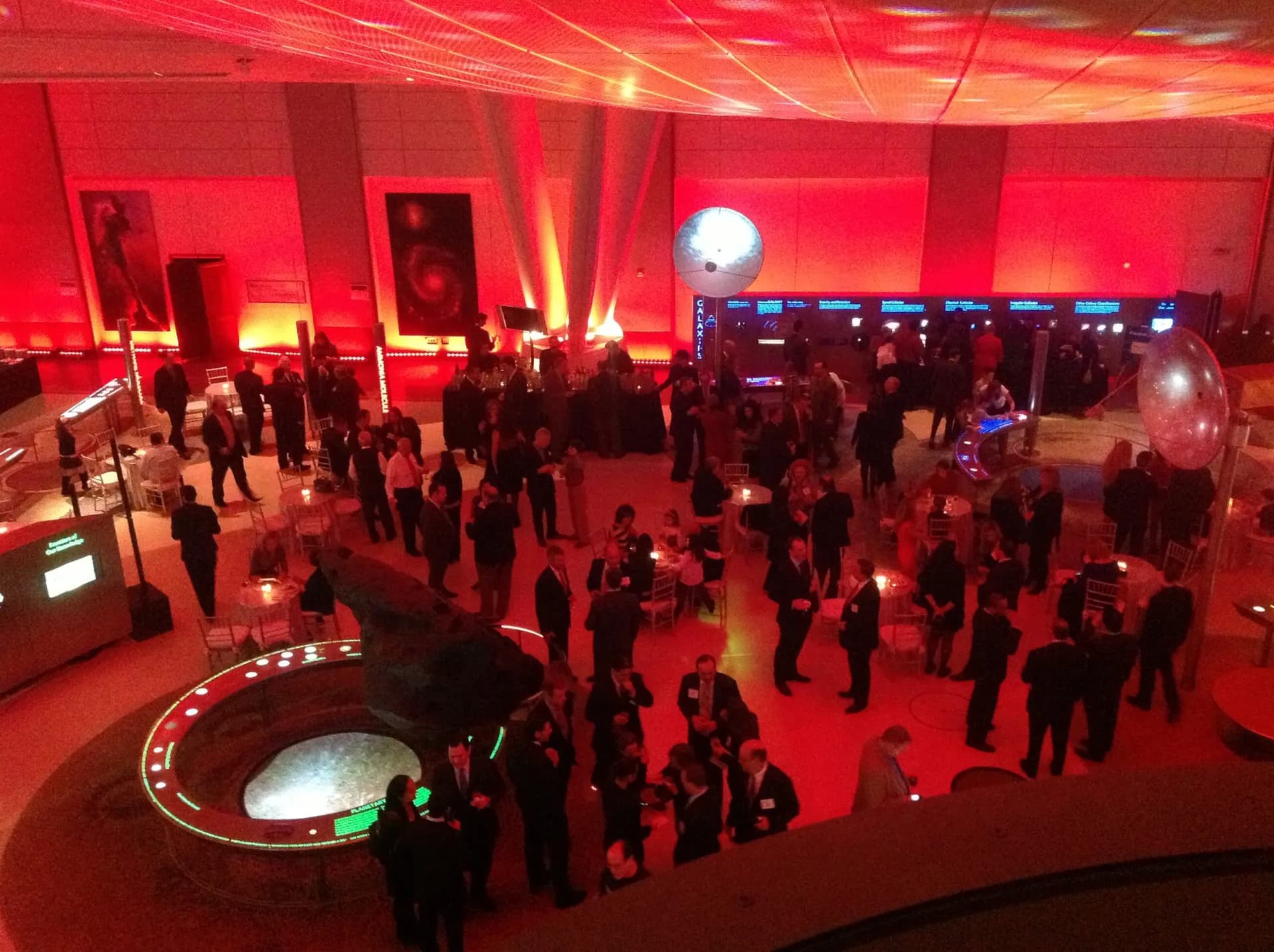 Aerial view of a luxury gala event with dramatic red uplighting