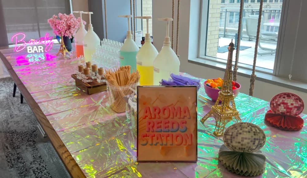 Guests crafting custom aroma reed diffusers with signature scent blends at a luxury event beauty and wellness station