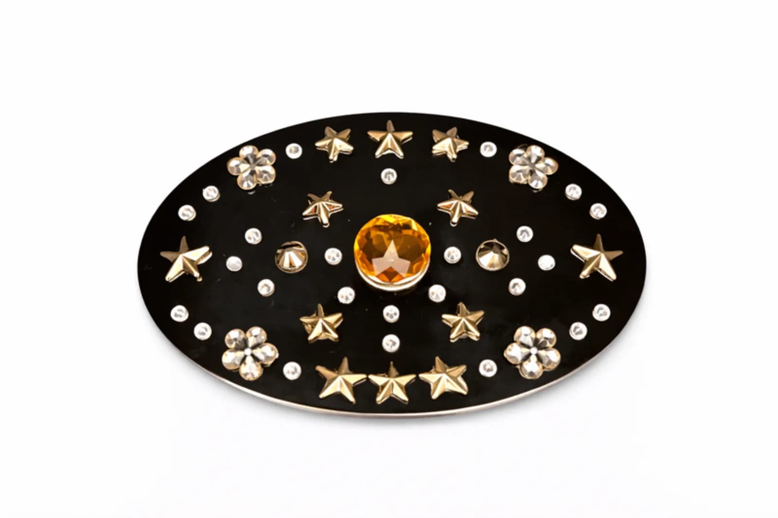 Black belt buckle bedazzled with gold star rhinestones and a center amber gem at a bling a belt buckle station