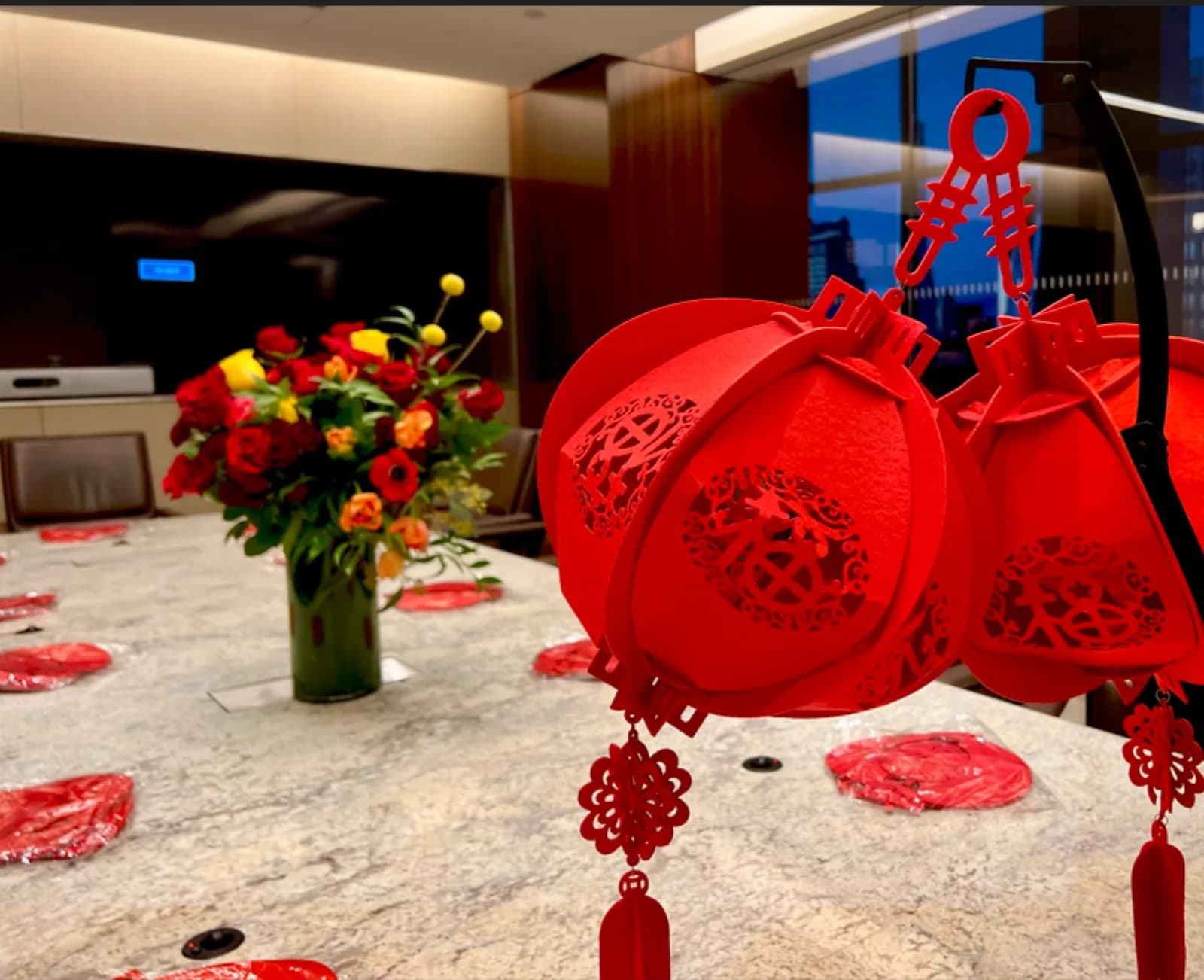 Finished lantern crafts displayed on a table with a floral centerpiece at a build a lantern station