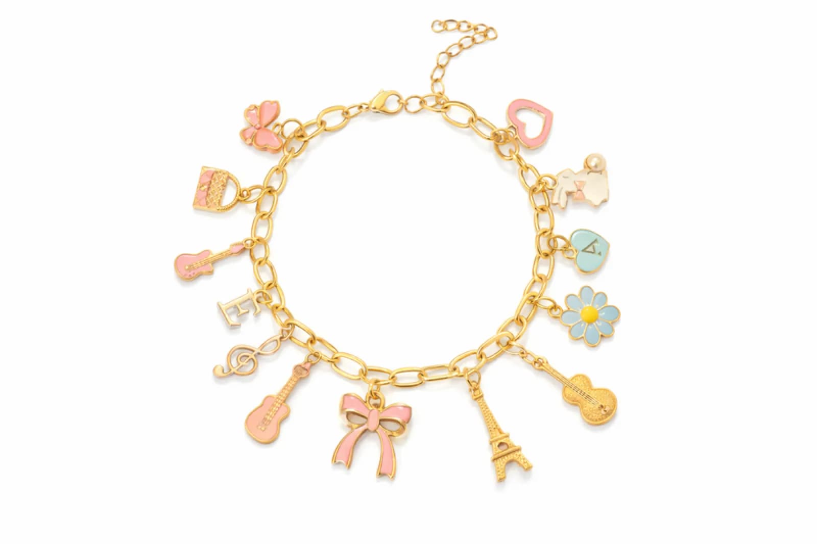 Gold charm bracelet with Eiffel Tower, guitar, and bow charms from a custom charm bracelet station