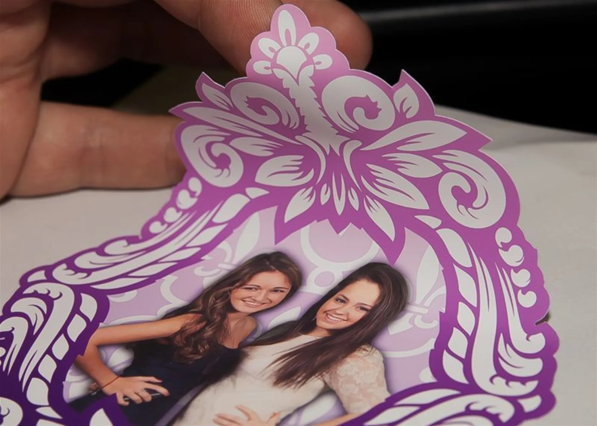Ornate purple photo cling favor held by a guest at a New York event
