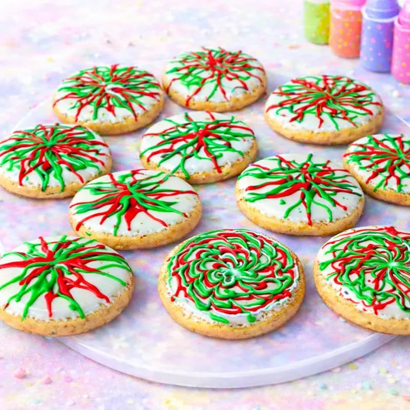 Spin art cookies decorated in red and green icing for a holiday-themed party