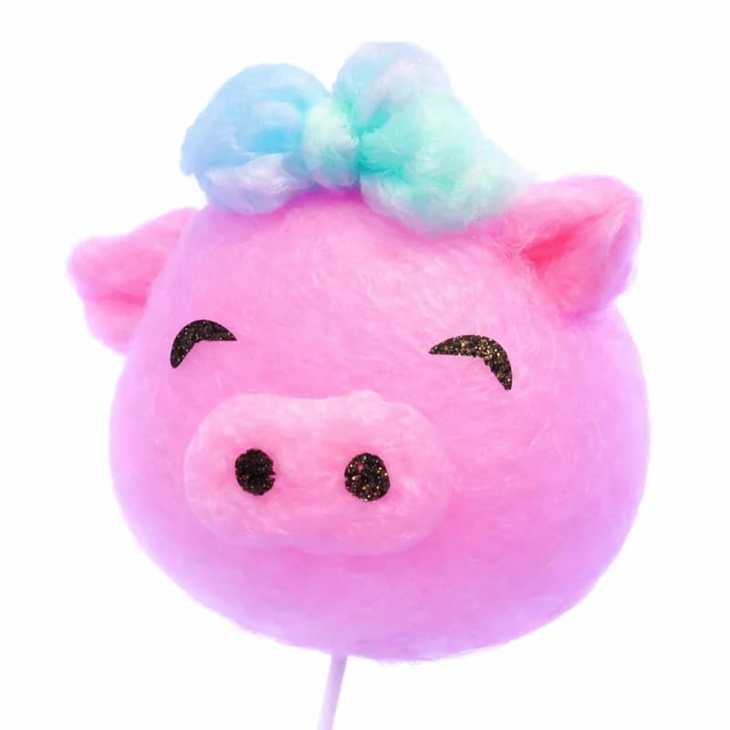 Cotton candy art hand-shaped into a smiling pig character with a bow
