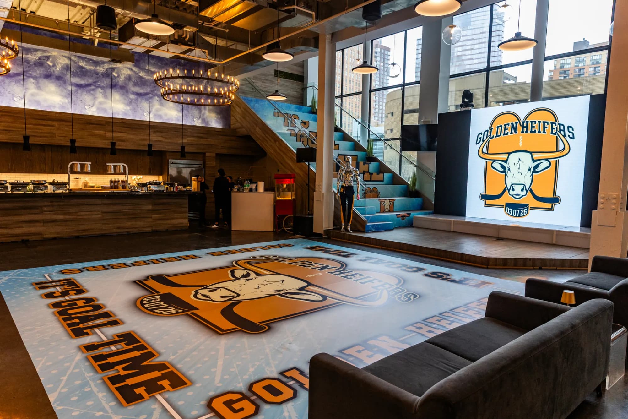 Wide-angle venue shot showing a full custom vinyl dance floor wrap with matching stair graphics and a large graphic backdrop at a branded corporate event