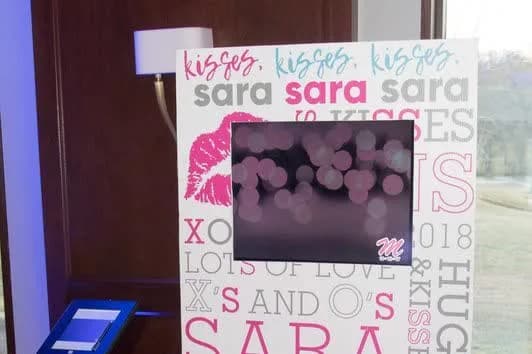 Branded digital guestbook sign-in board and iPad podium set up at an event