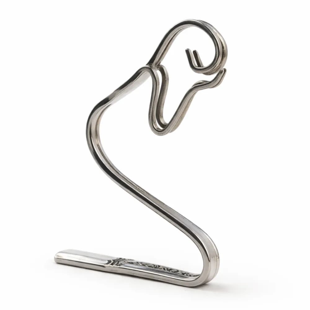 Fork art station with stainless steel forks hand-bent into sculptural keepsakes at an event
