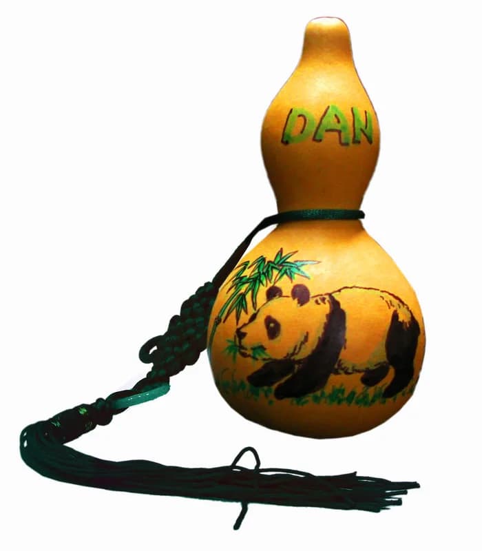Hand-painted mini gourd charm with a panda and bamboo design and the name Dan, a keepsake from the good fortune keepsakes station