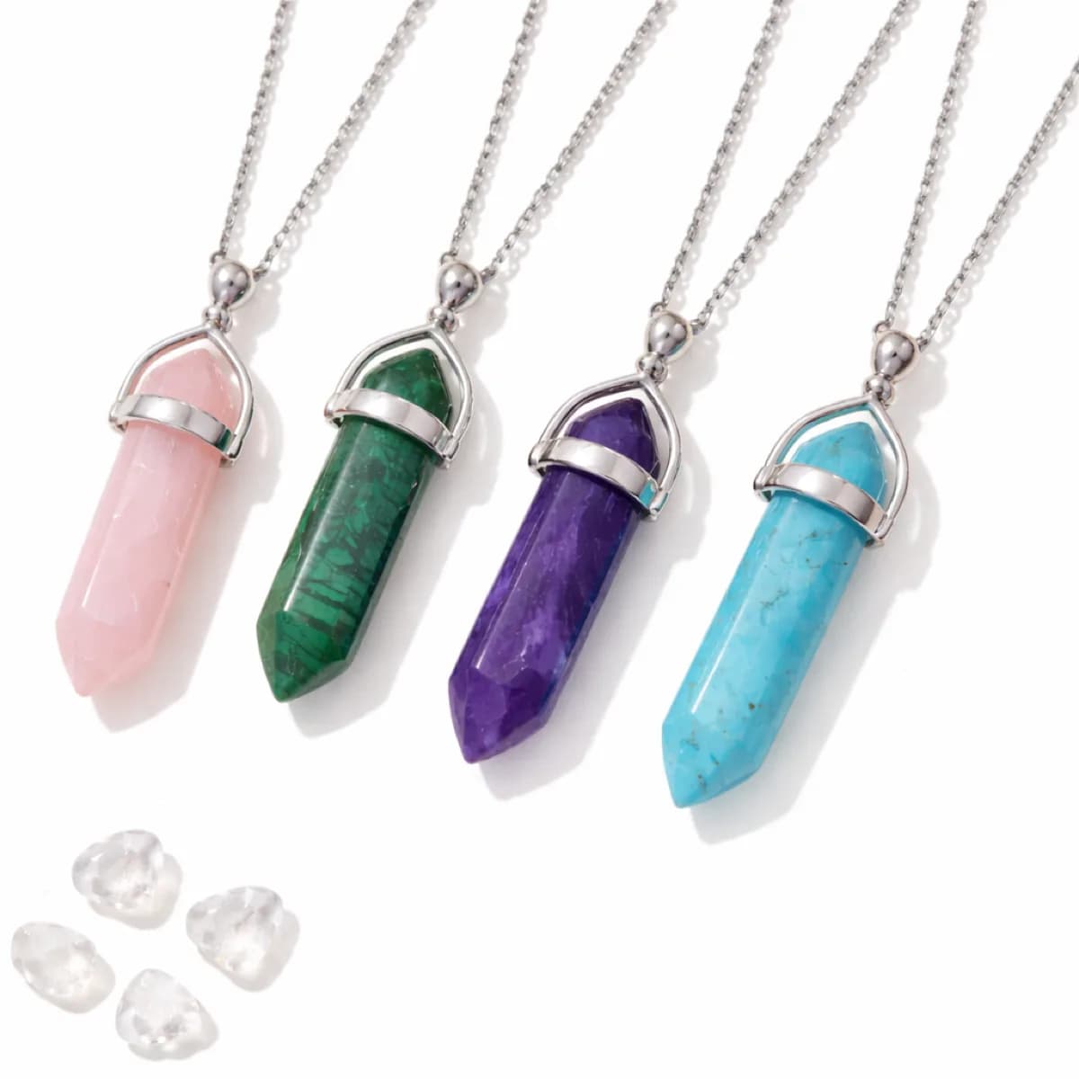 Rose quartz, malachite, amethyst, and turquoise gemstone pendant necklaces at an event jewelry station