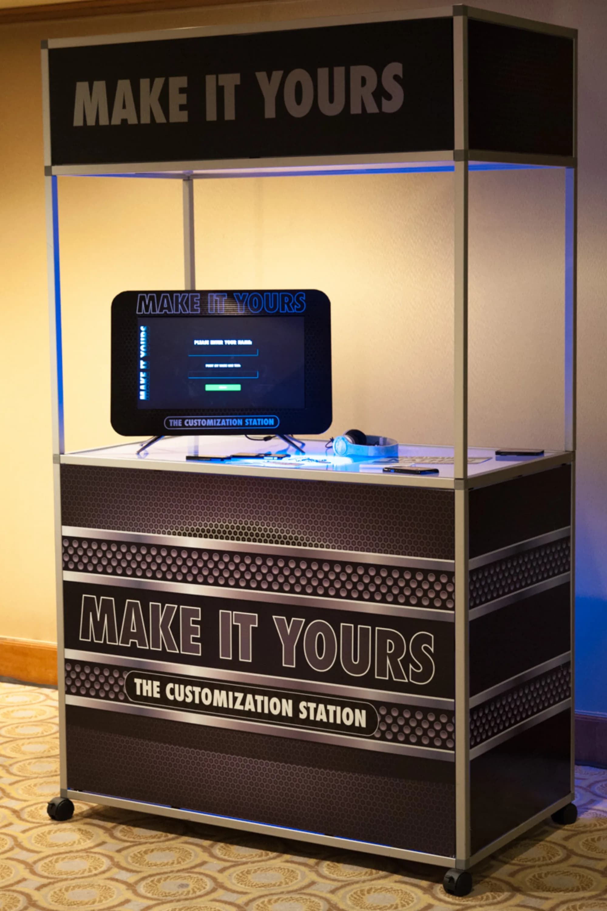 Full Make It Yours kiosk unit with branded touchscreen display and customization interface at a bar mitzvah