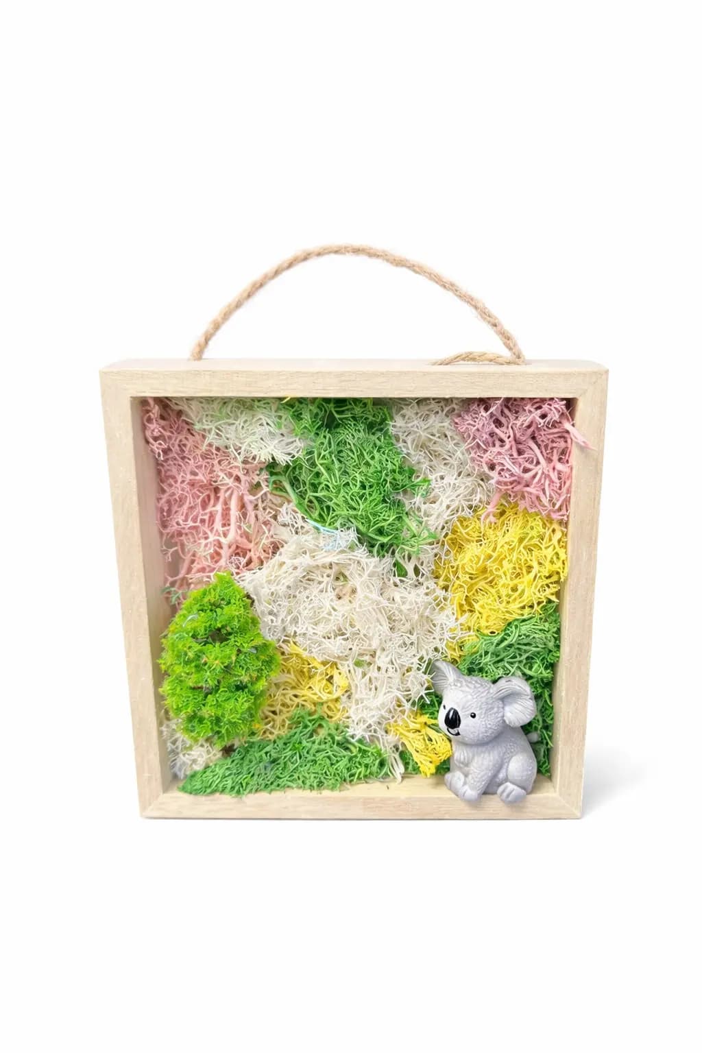 Framed moss wall art piece with pastel pink, green, and cream preserved moss and a small koala figurine, a keepsake from the moss wall art station
