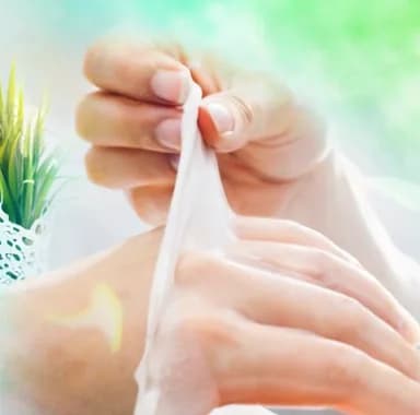 Guest peeling a warm paraffin wax treatment off the hand at a spa-themed event wellness station