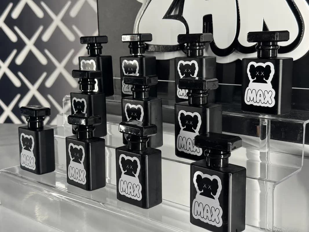 Close-up of personalized bottled cologne with a custom name label lined up at an event fragrance bar