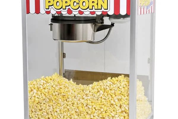 Classic striped popcorn popper filled with warm, fresh popped popcorn at an event