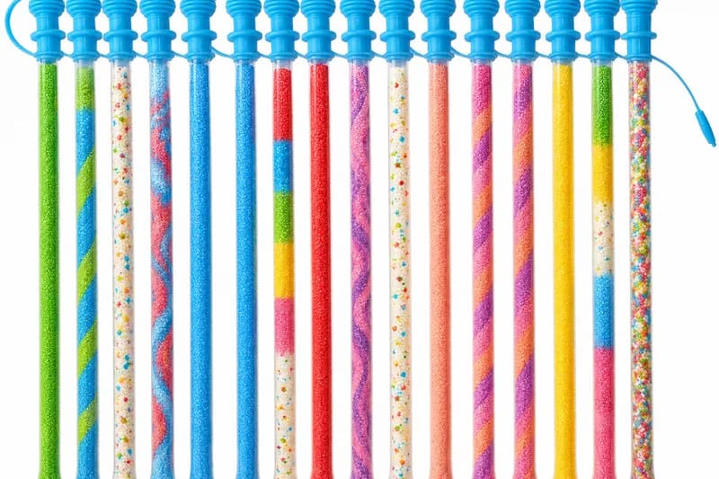 Rainbow-colored candy powder tubes lined up in assorted flavors at a Pucker Powder station