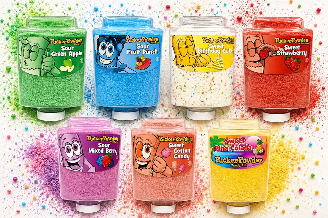 Assorted flavor bottles of colorful candy powder on display at a Pucker Powder party station
