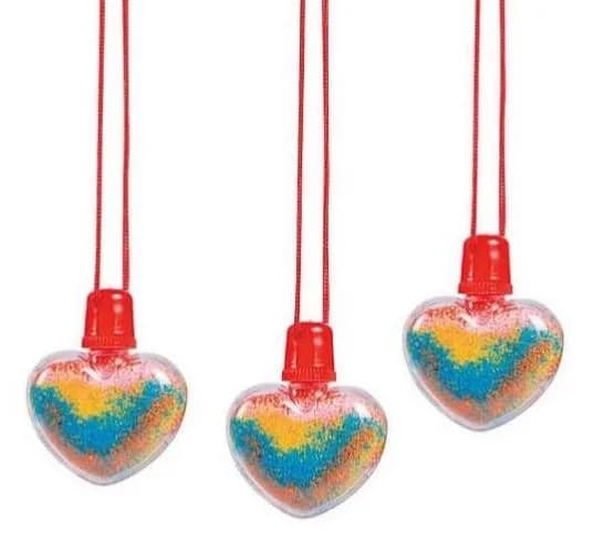 Three heart-shaped sand art necklaces filled with rainbow layered sand on red cords