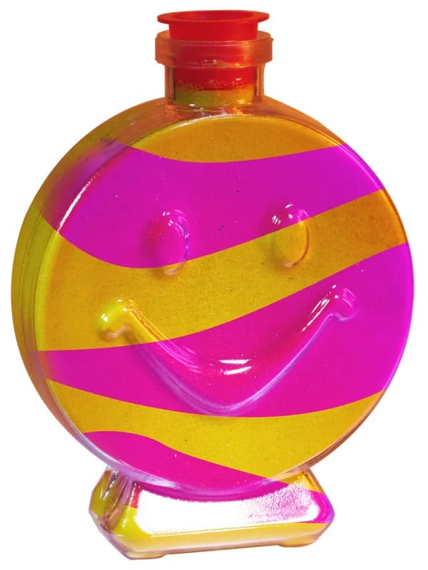 Smiley face shaped bottle filled with layered pink and yellow sand at a sand art station