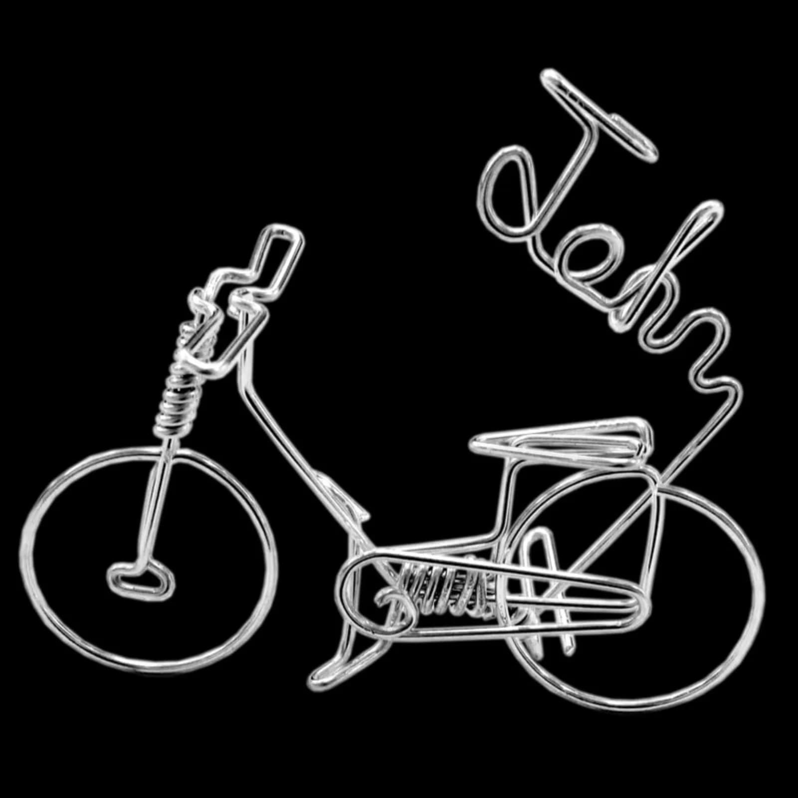 Wire art piece bending a guest name into a bicycle design, a keepsake from the wire art station