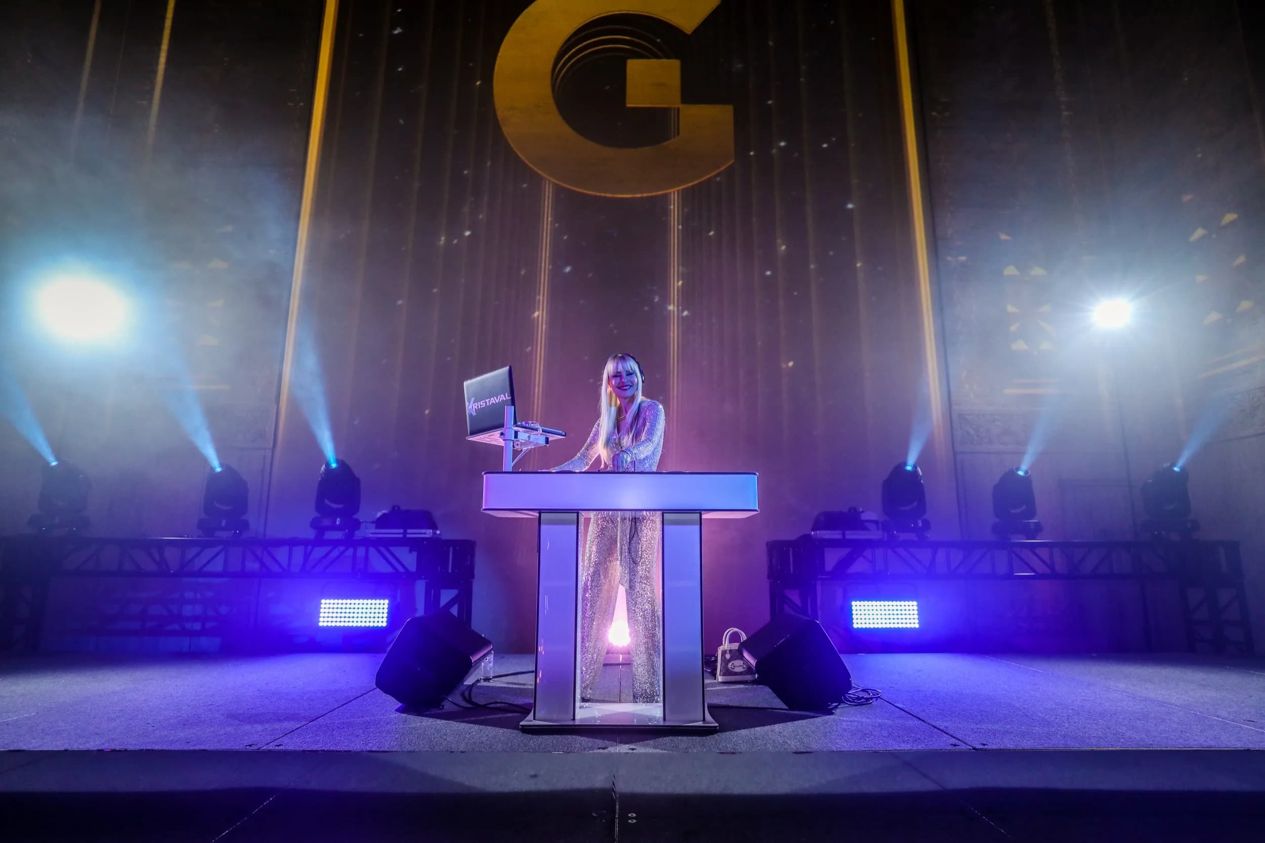 DJ Kristaval on stage surrounded by production lighting at a large-scale event