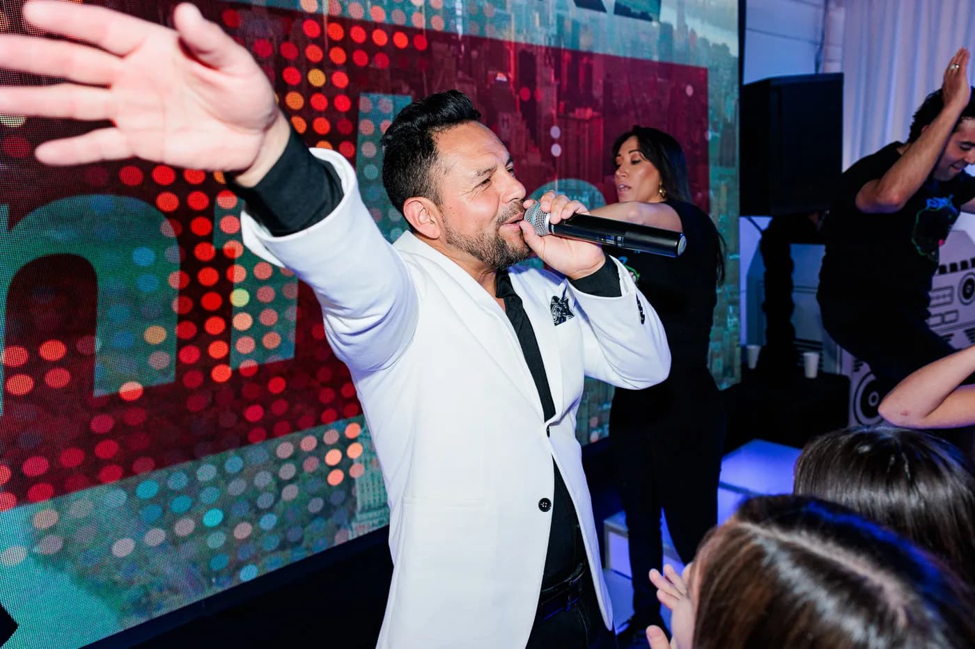 Performer on stage with a microphone working a live crowd at a Nicholson Events production