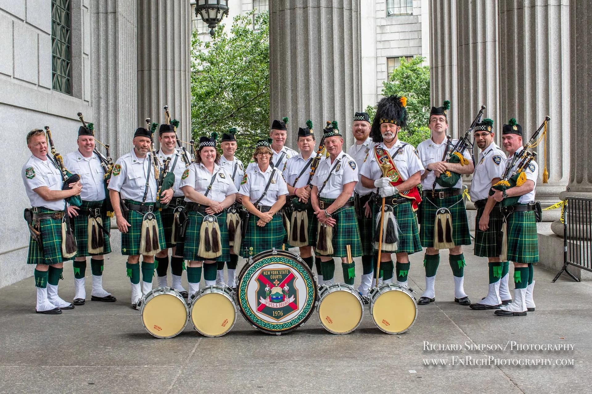 Irish bagpipe band in traditional dress performing at an outdoor event