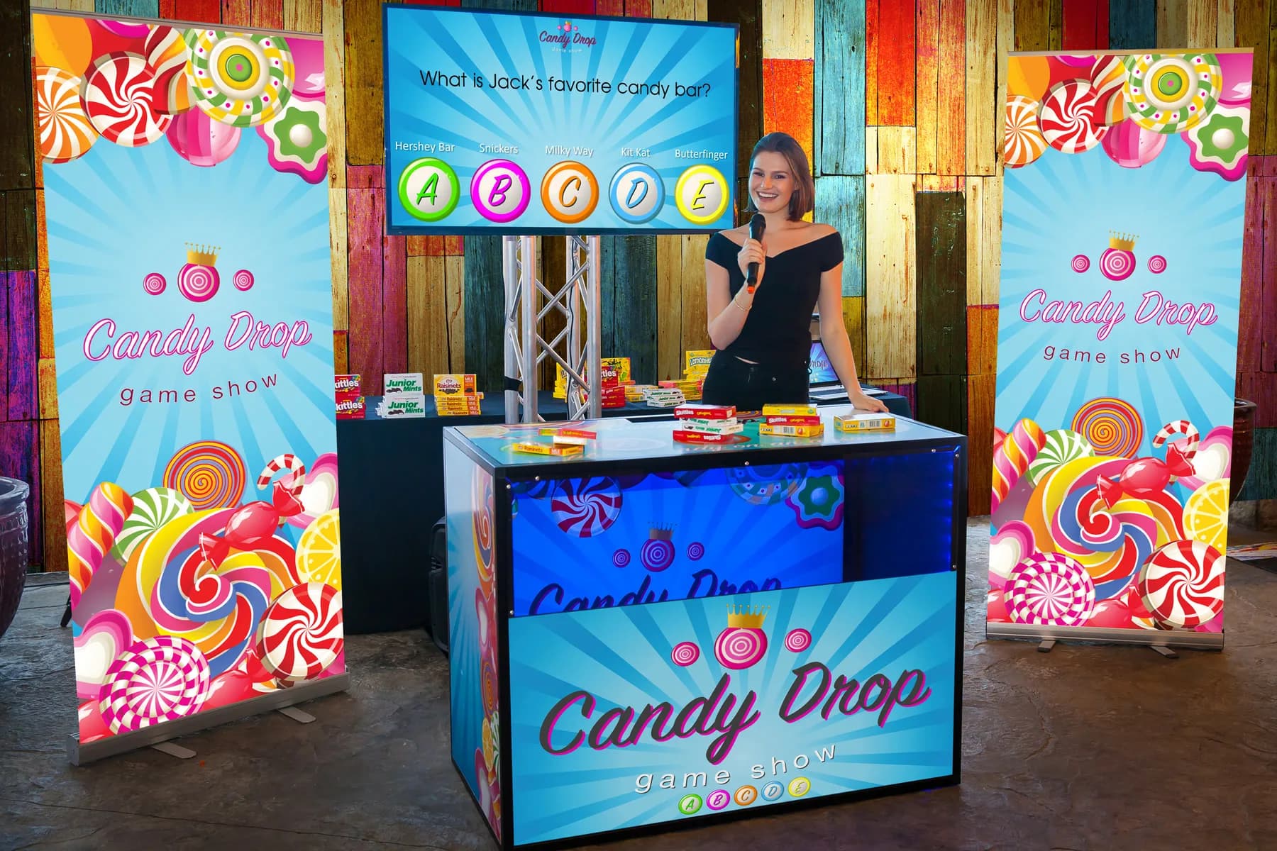 Candy drop game show at a bar mitzvah party, guests answering trivia questions to win candy prizes from an overhead dispenser
