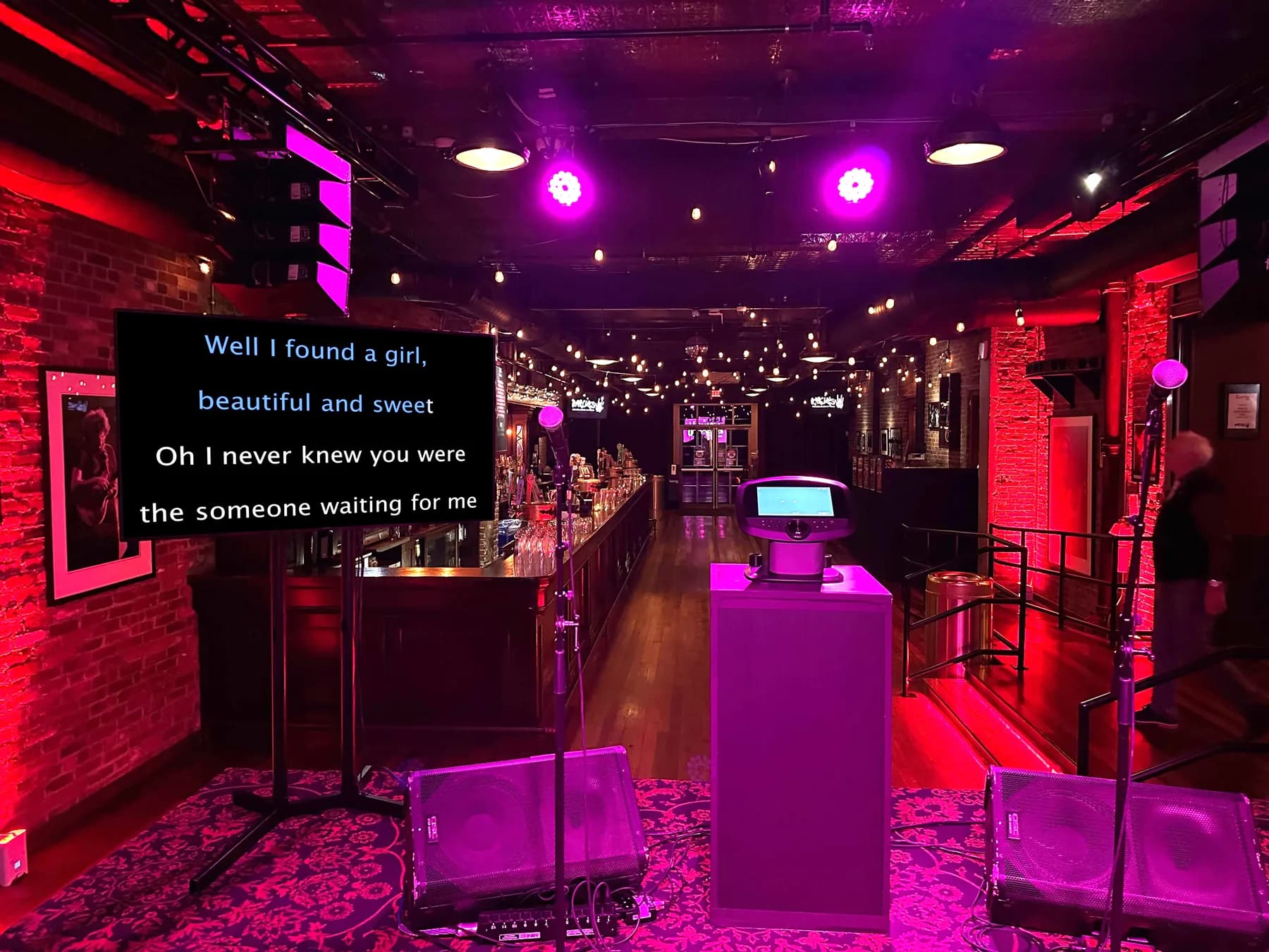 Karaoke venue setup with lyric screen and purple stage lighting for mitzvah party entertainment