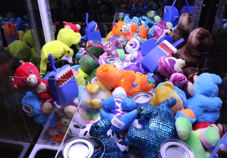 Inside of the prize crane stocked with colorful plush toys and giveaways at a bar mitzvah or corporate event in New York