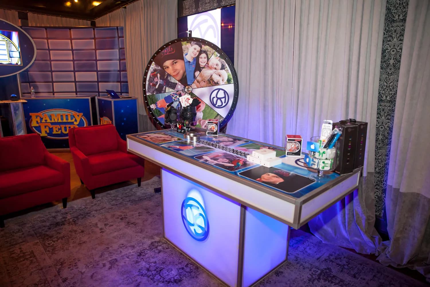Prize wheel game show at a corporate event or bar mitzvah in NYC, guests spinning the large branded prize wheel to win prizes