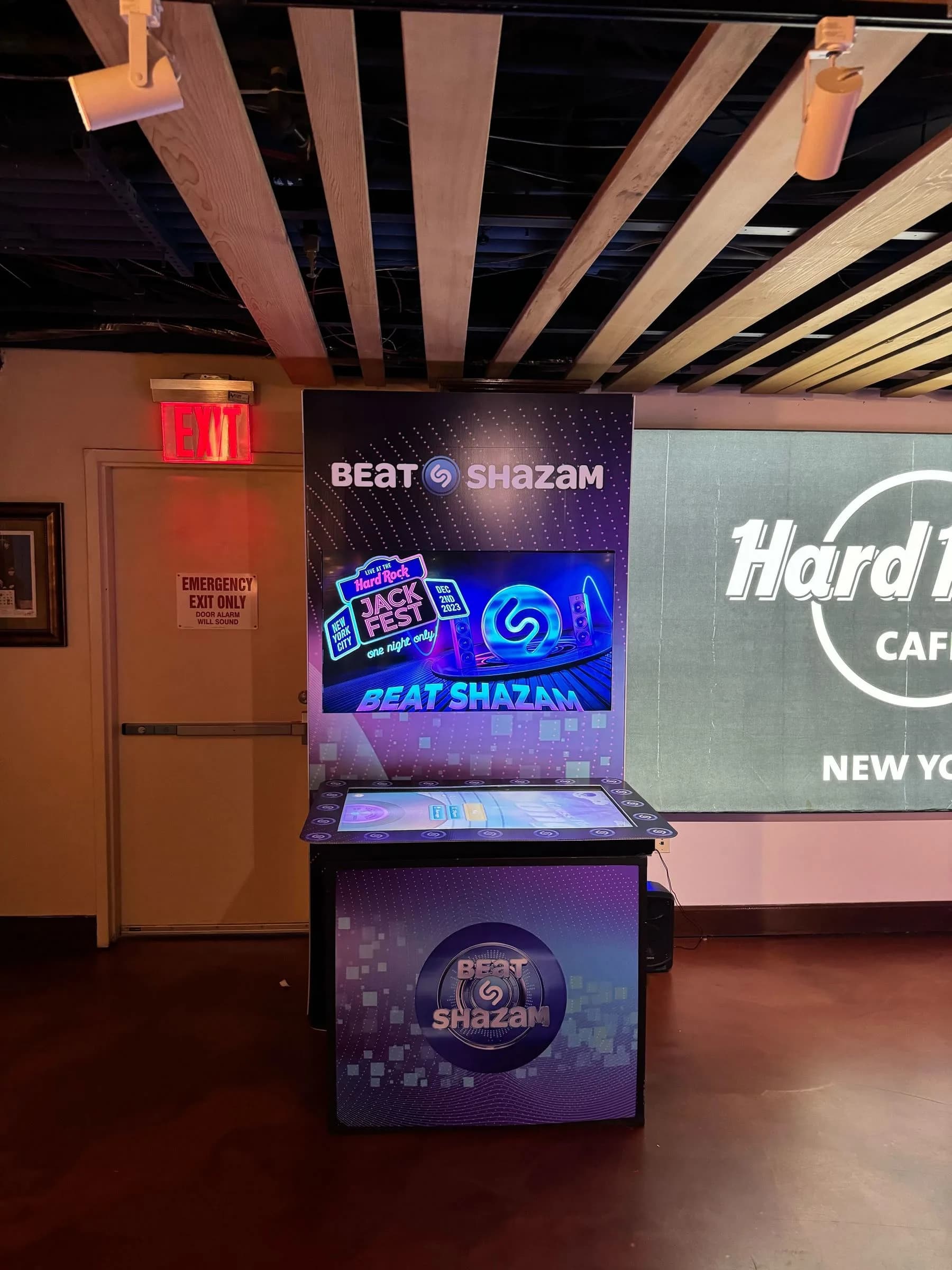 Music trivia game show kiosk display showing song playlist categories at a corporate holiday party or gala in CT or NYC