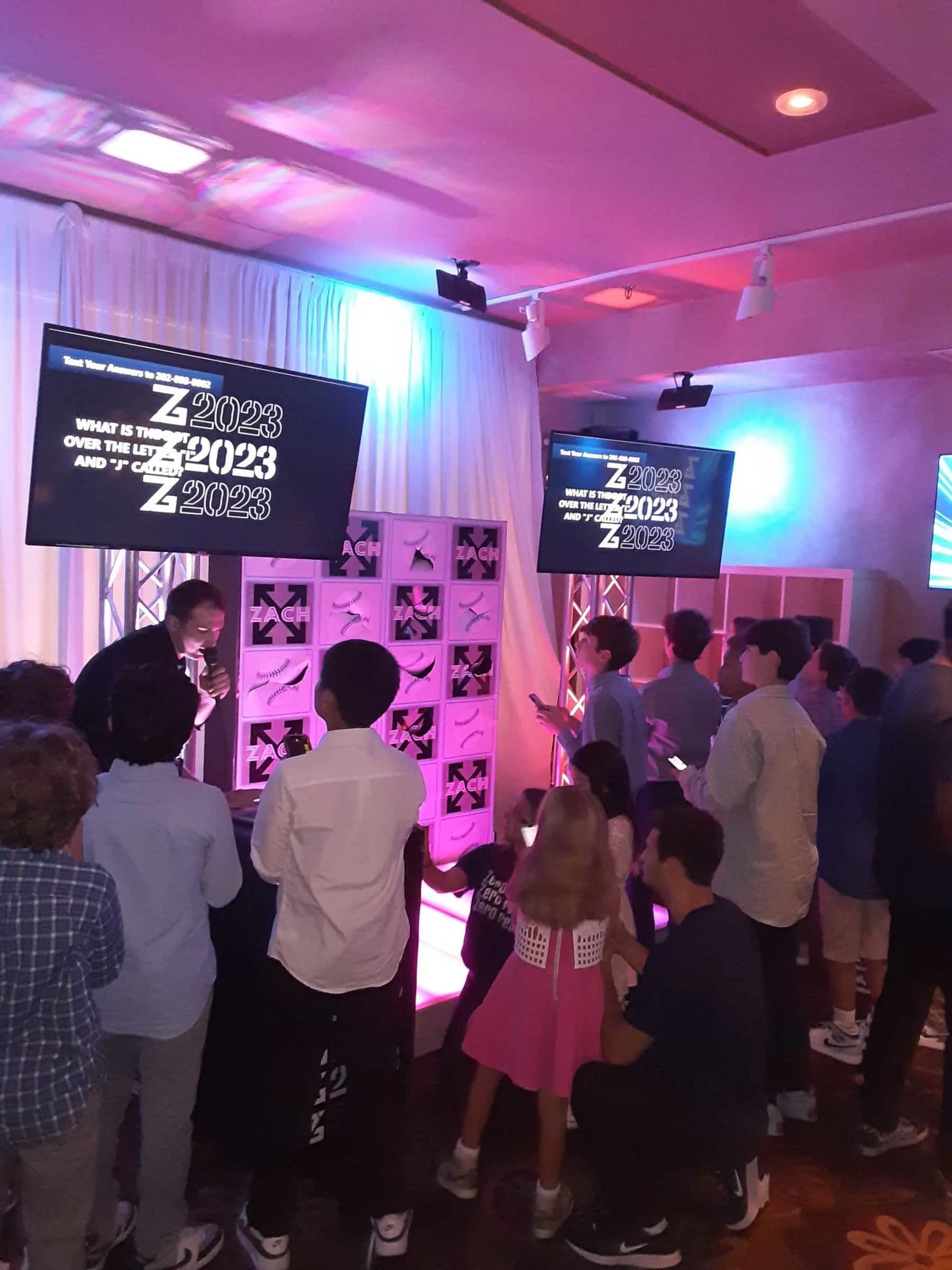 Guest punching a prize cubby after winning the text-to-win trivia game at a corporate gala or mitzvah celebration in CT or NYC