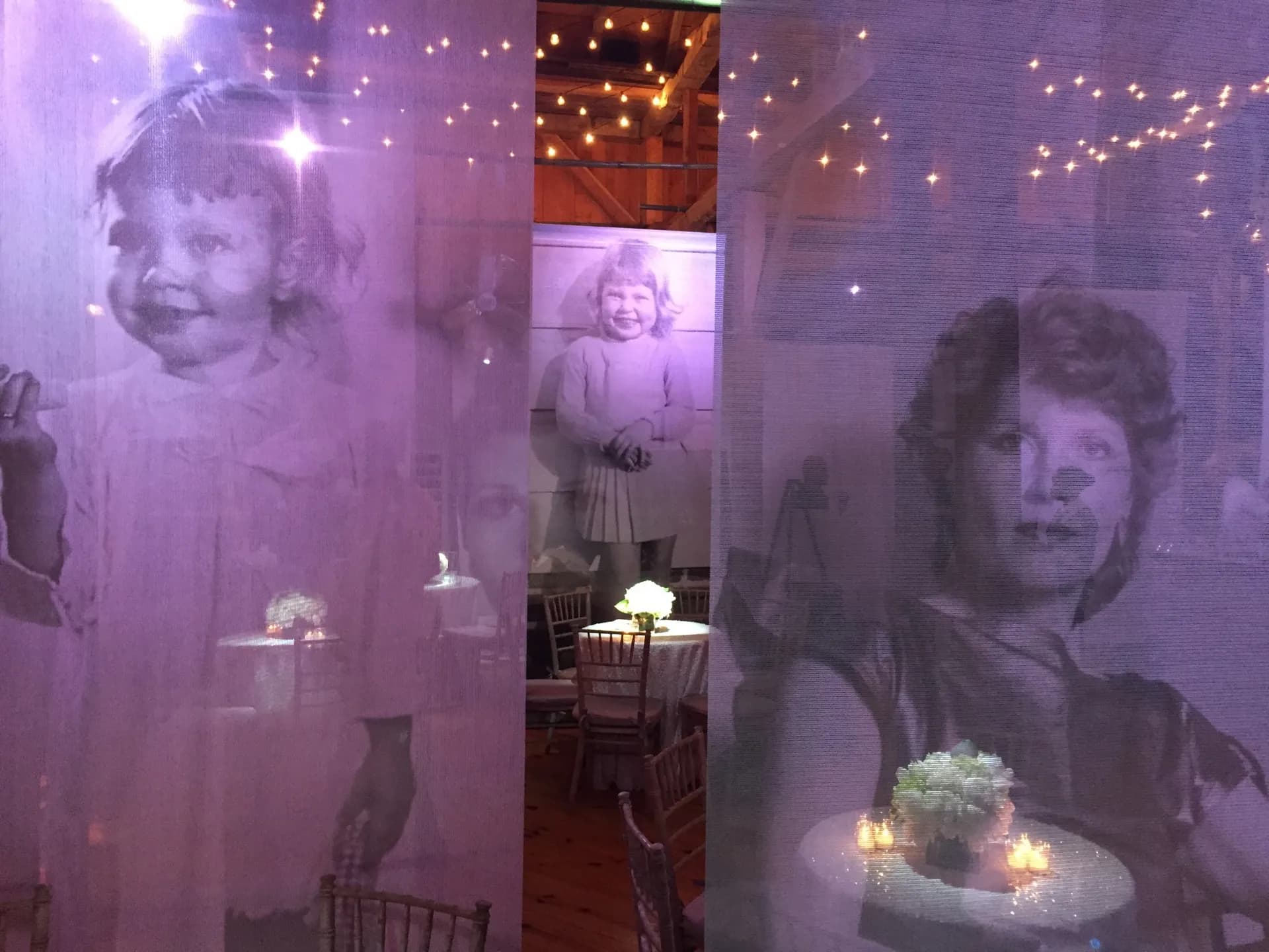 Vintage family photos rear-projected onto suspended sheer scrim panels at a bat mitzvah at The Knowlton