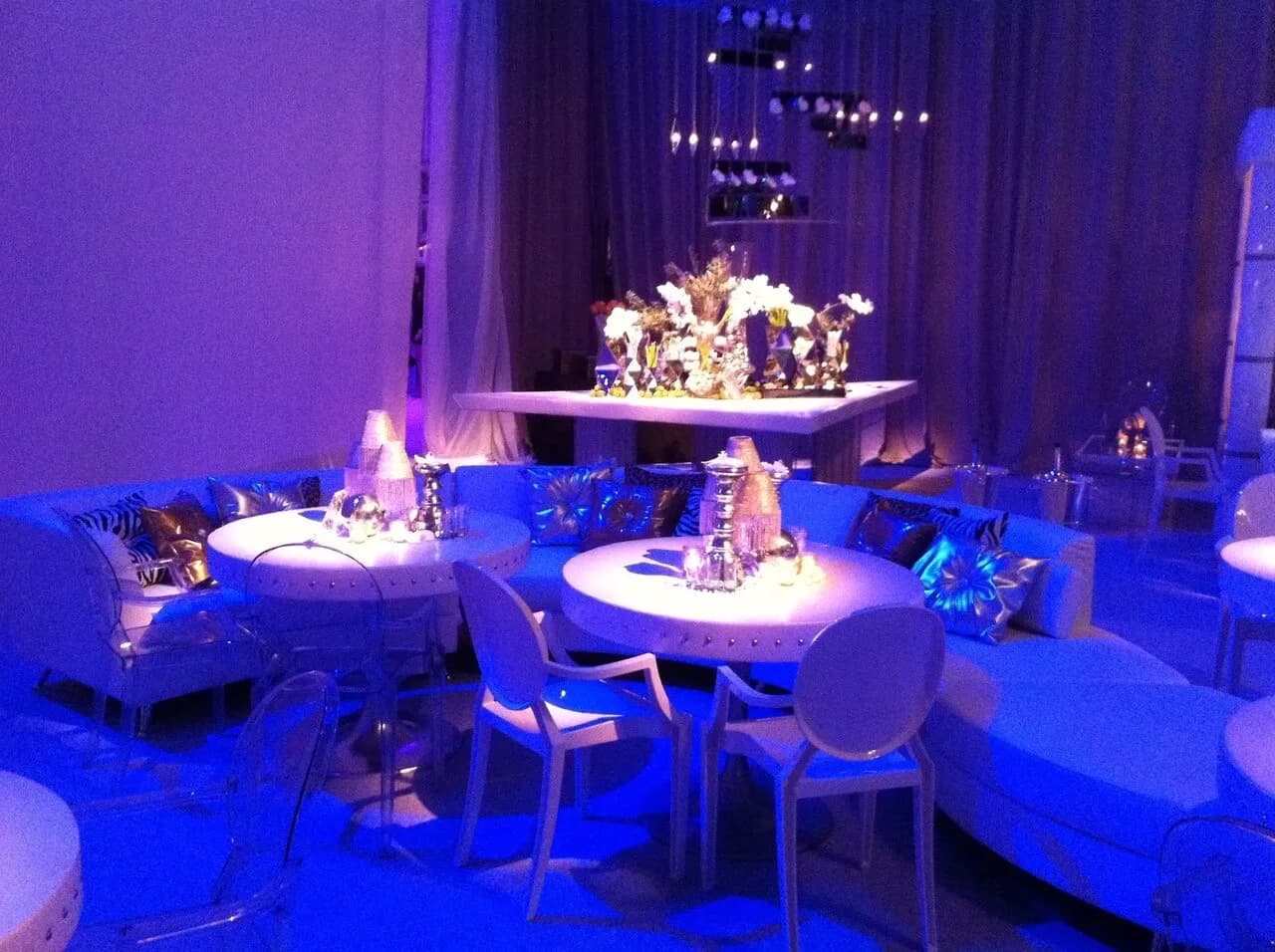 Bar mitzvah lounge area with blue LED uplighting and modern decor setup