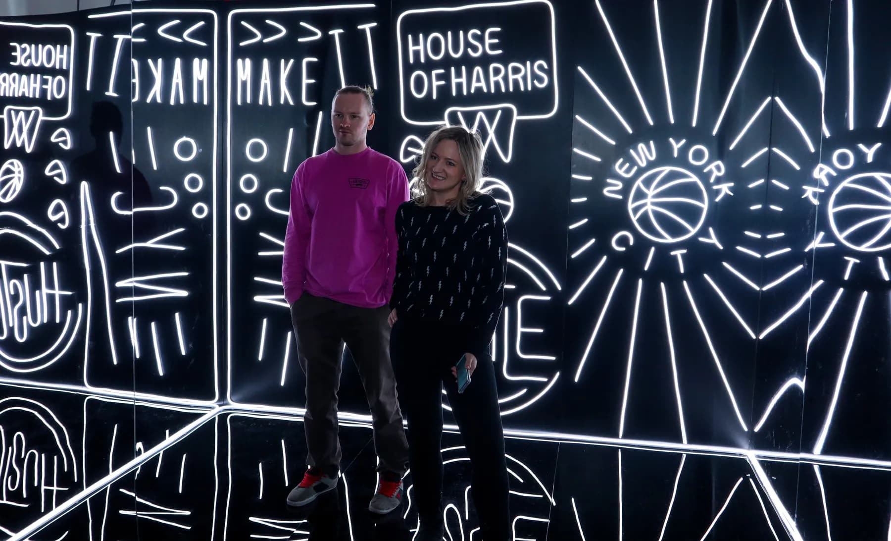 Group photo in front of the Neon Wall at a brand activation event