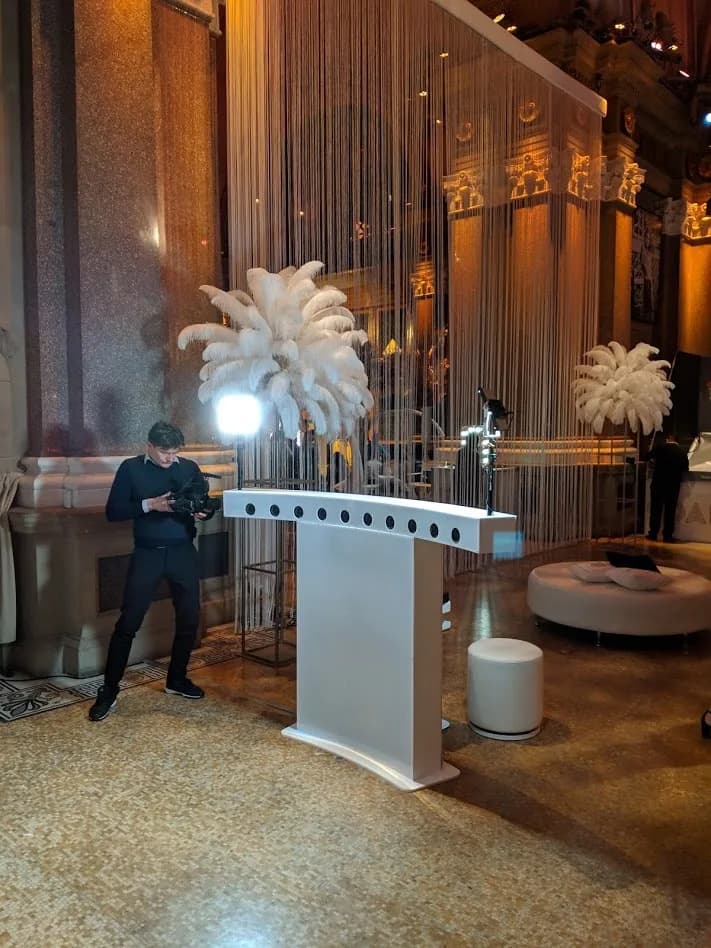 Time-freeze camera array bar rig being set up at an elegant ballroom event with high ceilings