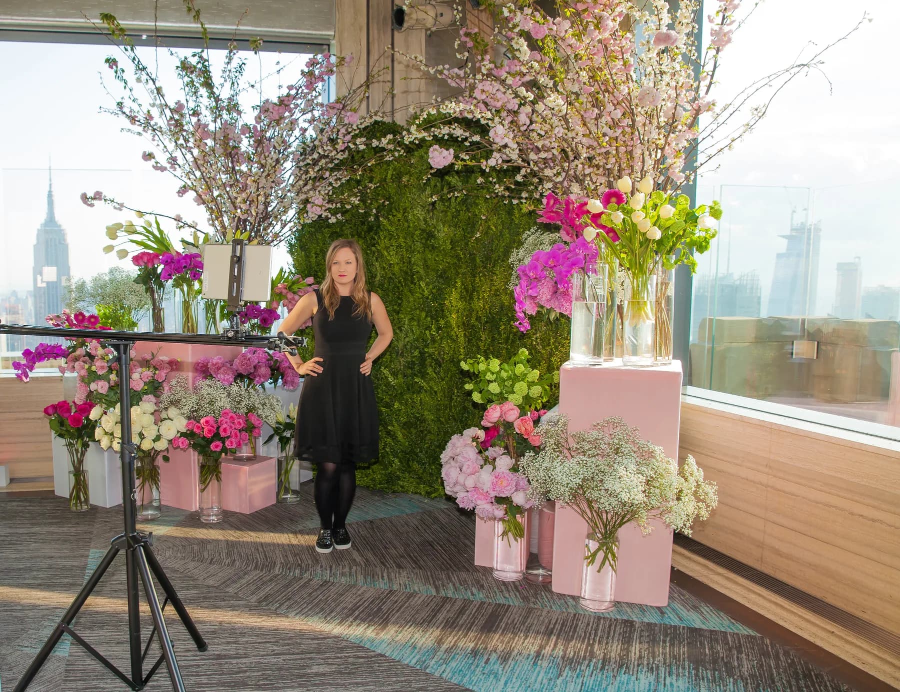 Sliding 180 GIF rail setup at a high-rise venue with NYC skyline visible through floor-to-ceiling windows