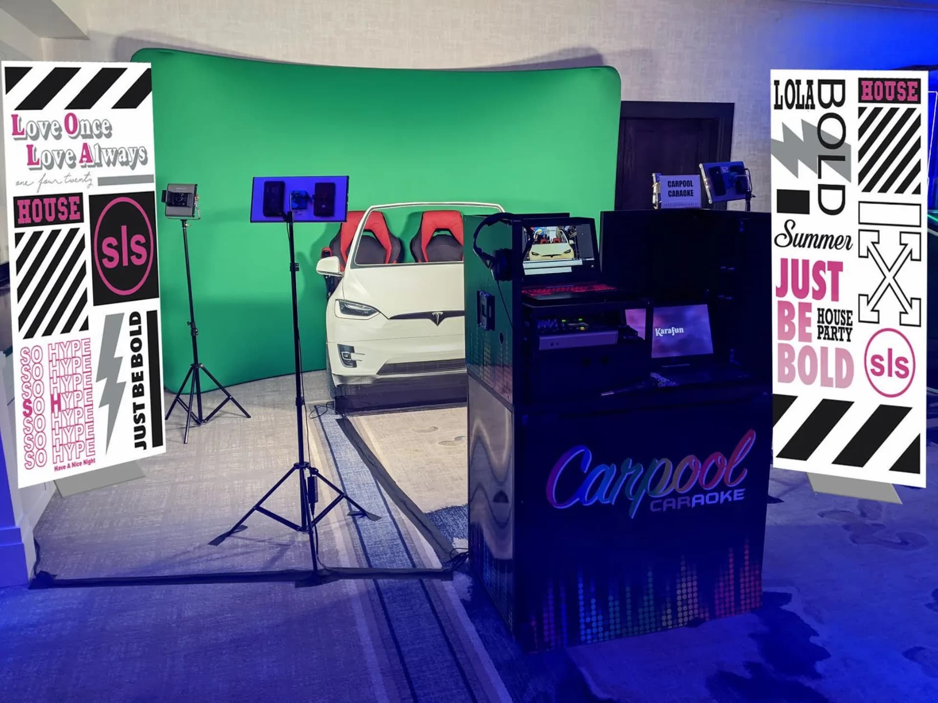 Open-air car booth karaoke setup with green screen, car facade, and recording station in the event space
