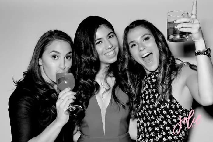 Black-and-white glam booth print of three young women celebrating at a sweet 16 party
