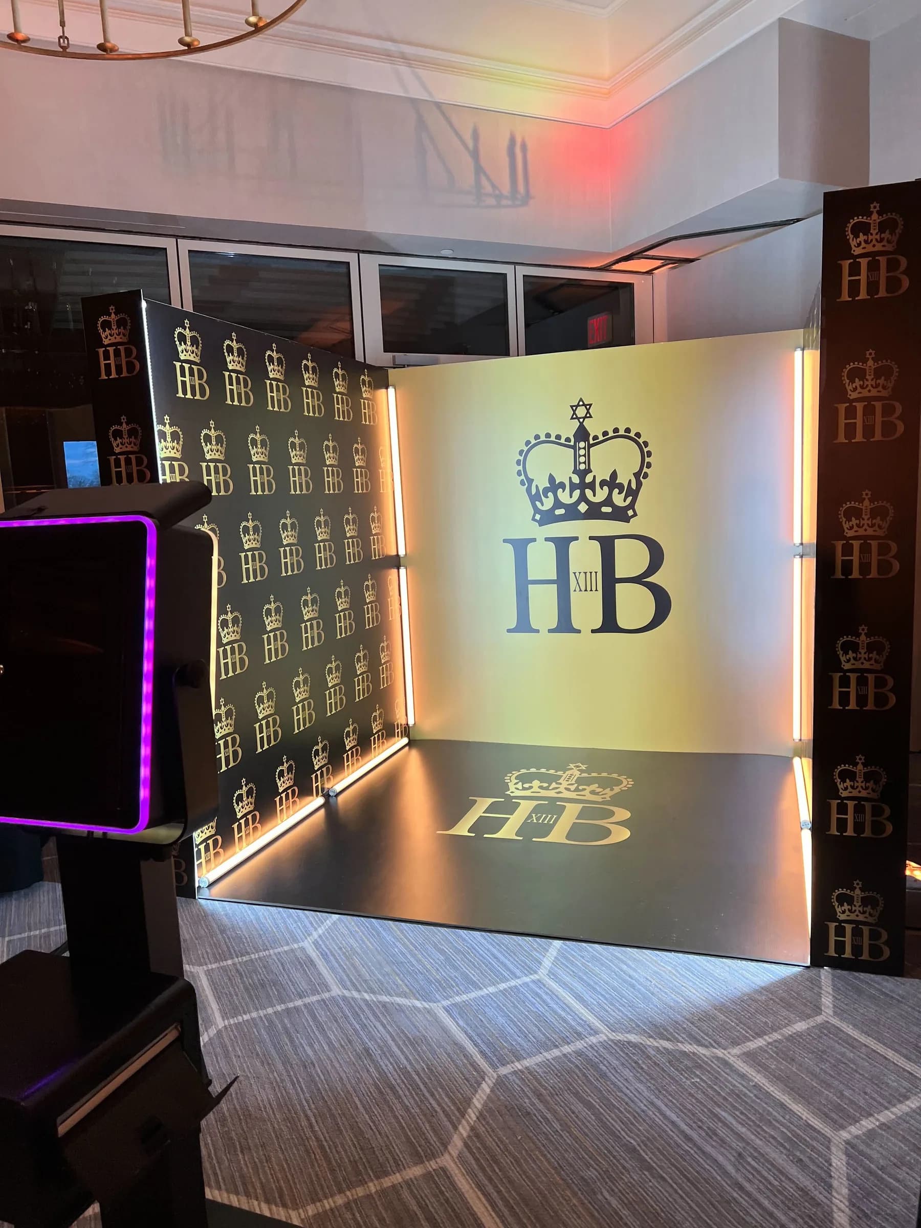 Custom immersive booth with elegant monogram step-and-repeat backdrop and mirrored floor at a bar mitzvah in Connecticut