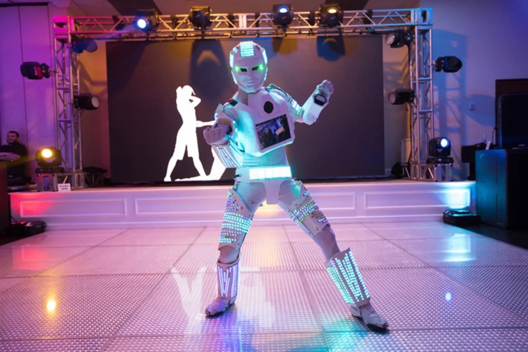 Photo-bot roaming attendant in full LED robot costume on a mitzvah dance floor
