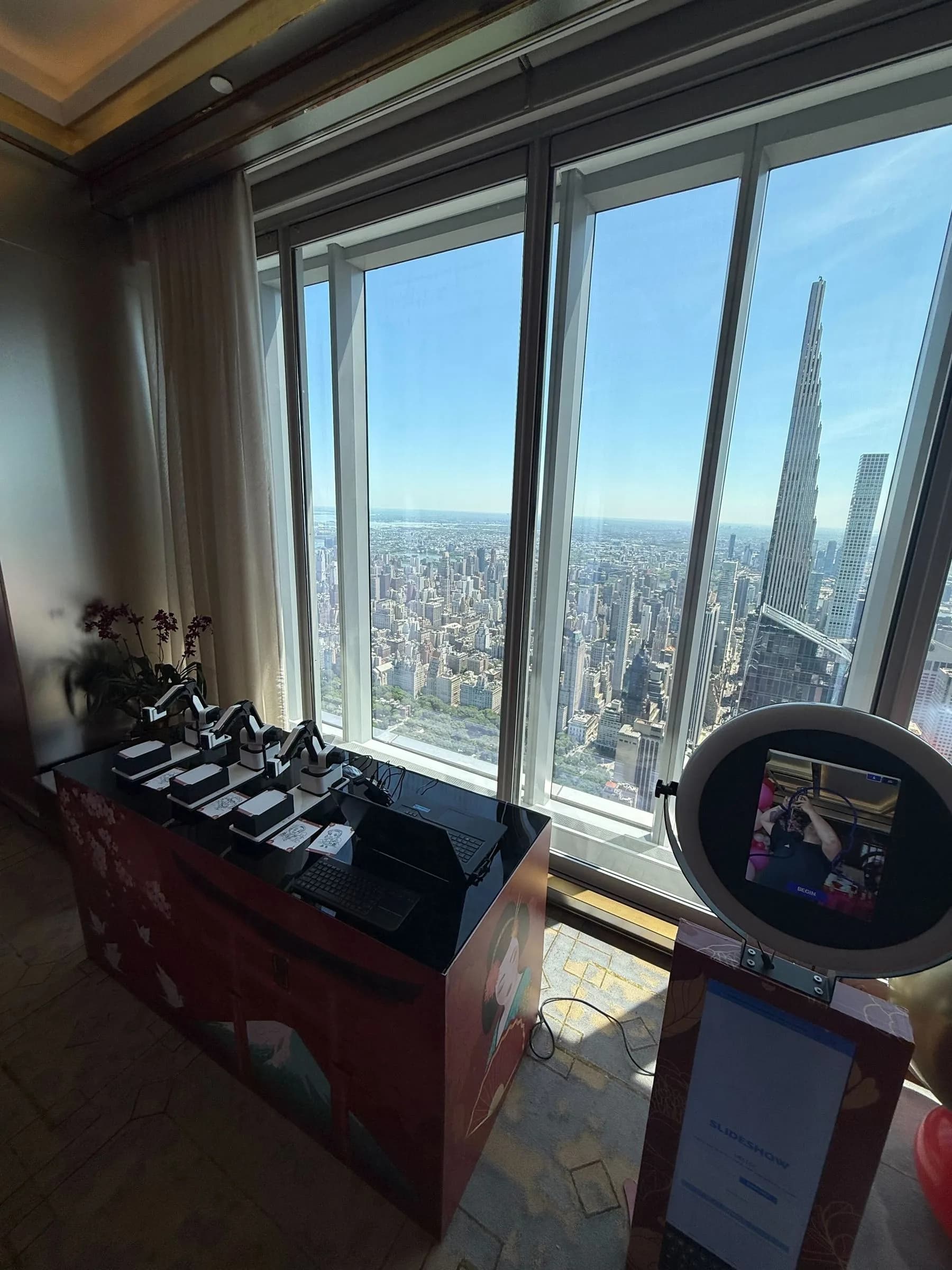 SketchBot full event setup with ring-light camera kiosk and robot arms at a New York City venue